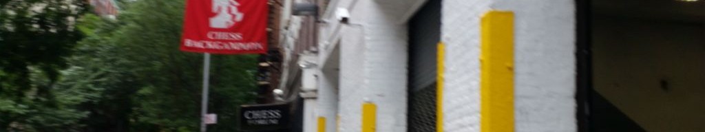 Street-level low light example from Downtown Manhattan Nyc, cropped to the local street backdrop.